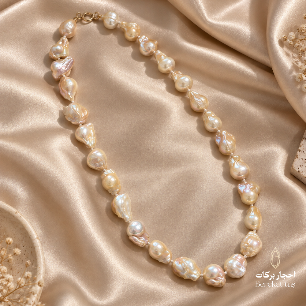 Handmade natural Pearl necklace arranged on champagne satin with delicate floral accents