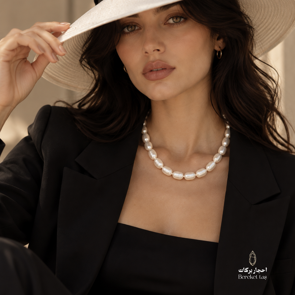 Natural Pearl handmade necklace styled with a black blazer and wide-brim hat, highlighting the elegant oval pearl design