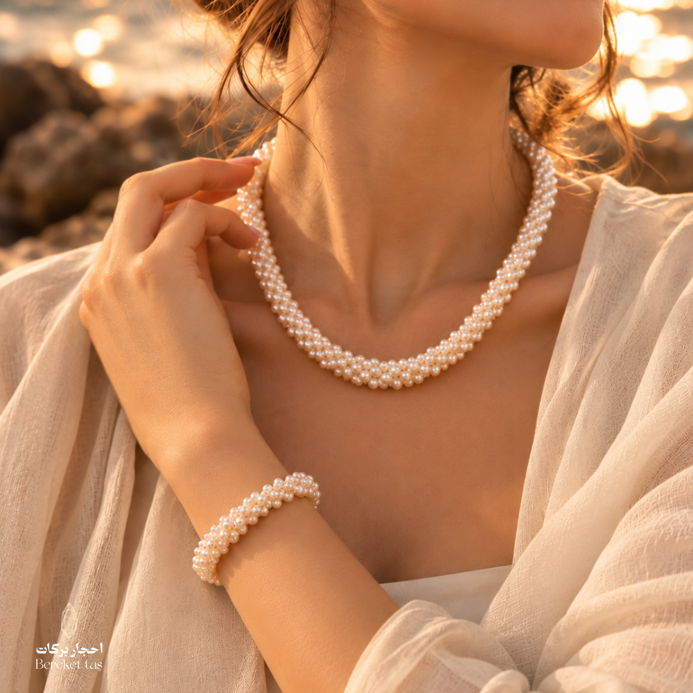 Woman wearing a natural pearl necklace and matching bracelet jewelry set
