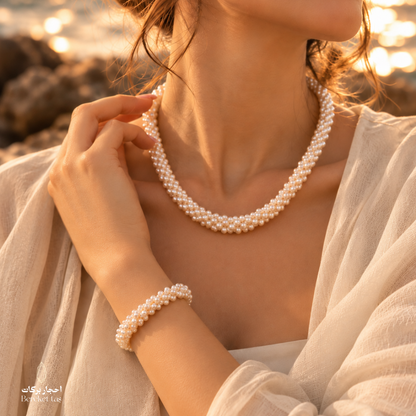 Woman wearing a natural pearl necklace and matching bracelet jewelry set
