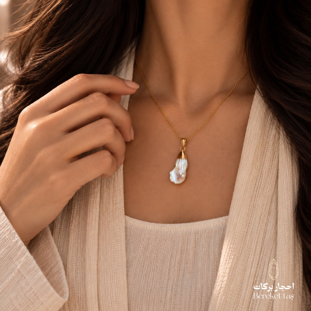 Close-up of a natural white Pearl pendant necklace with a gold-plated chain worn elegantly