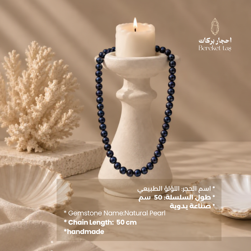 Handmade natural Pearl necklace with deep navy and black tones displayed with elegant decor
