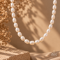 Close-up view of a natural Pearl necklace highlighting the luminous oval-shaped beads and elegant handmade design