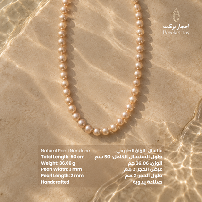 Natural Pearl handmade necklace displayed on a warm stone surface with 50 cm length and pearl size details