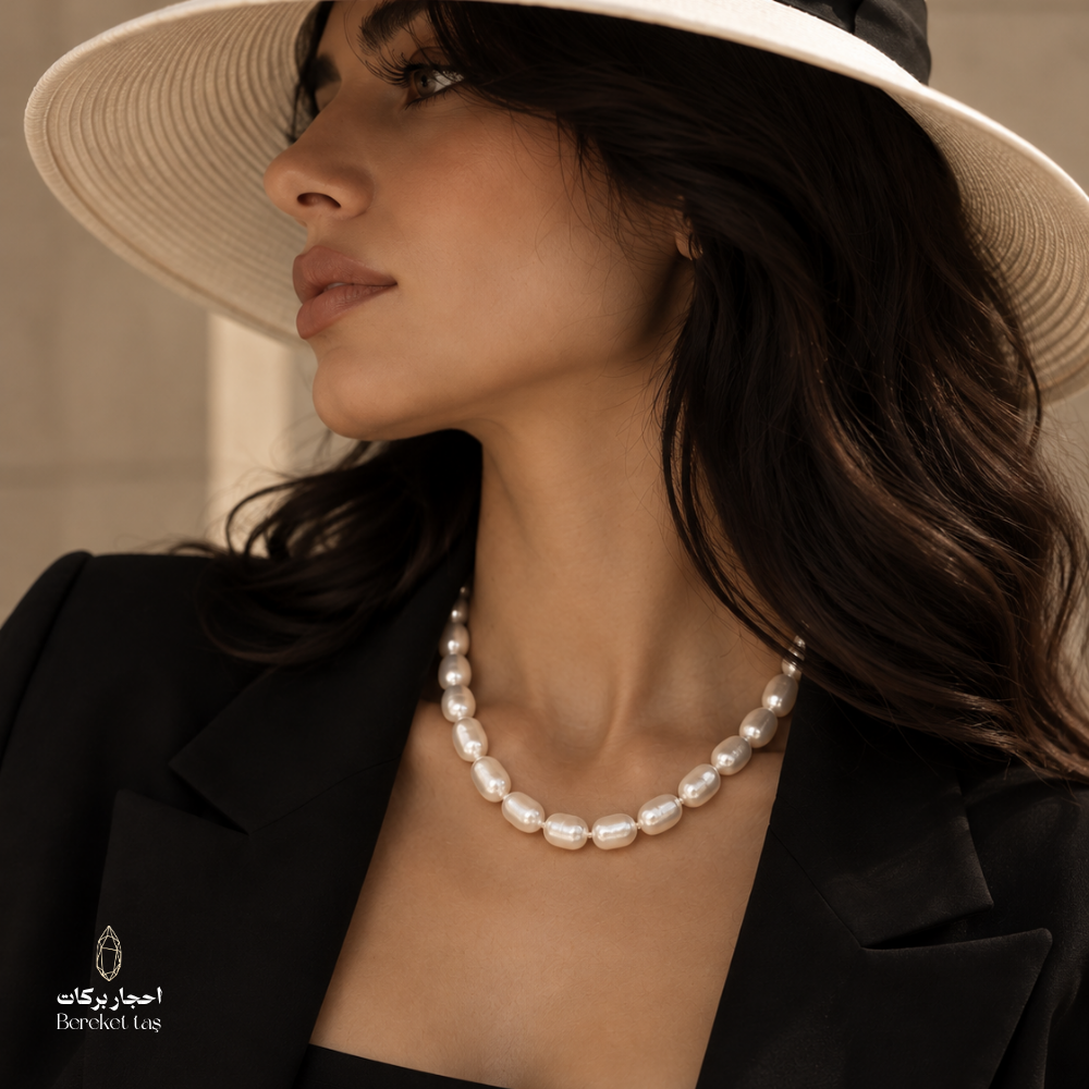 Natural Pearl handmade necklace worn with a black blazer and wide-brim hat, showcasing the luminous pearl arrangement