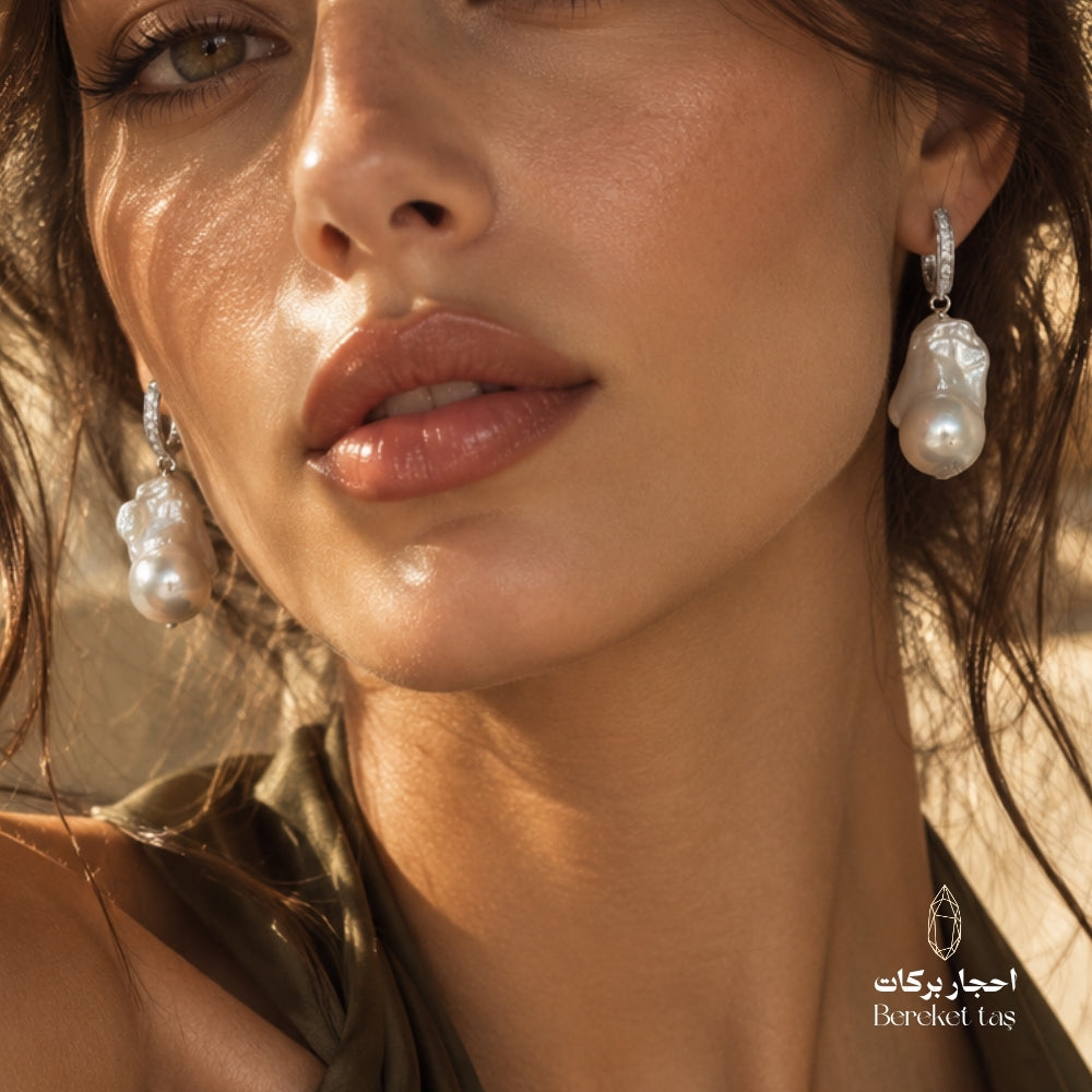 Close-up of natural Pearl earrings with 925 sterling silver, worn in an elegant look