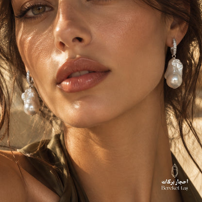 Close-up of natural Pearl earrings with 925 sterling silver, worn in an elegant look