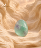 Natural polished green fluorite stone with purple inclusions displayed against a warm beige background