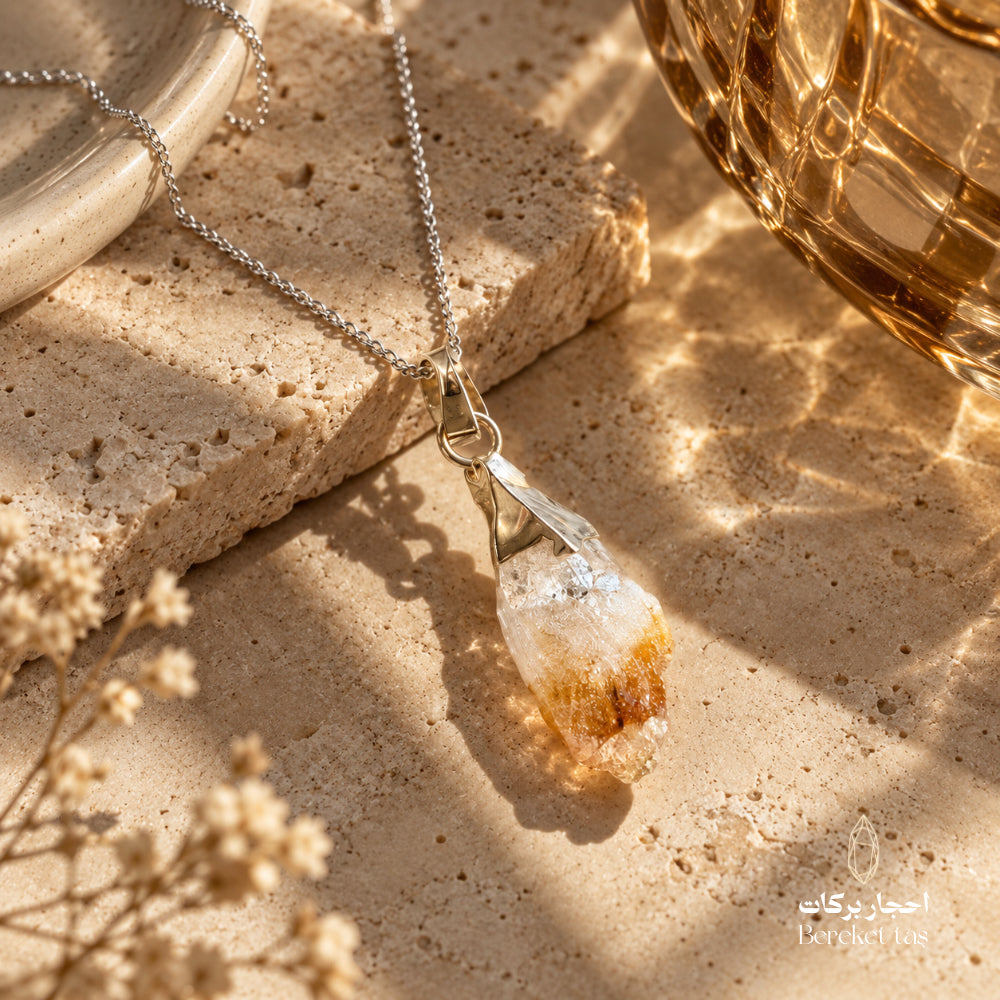 Natural raw Citrine silver pendant necklace displayed on a warm stone surface with elegant decor