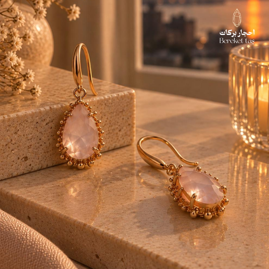Natural Rose Quartz earrings with a teardrop cut and gold-plated decorative frame
