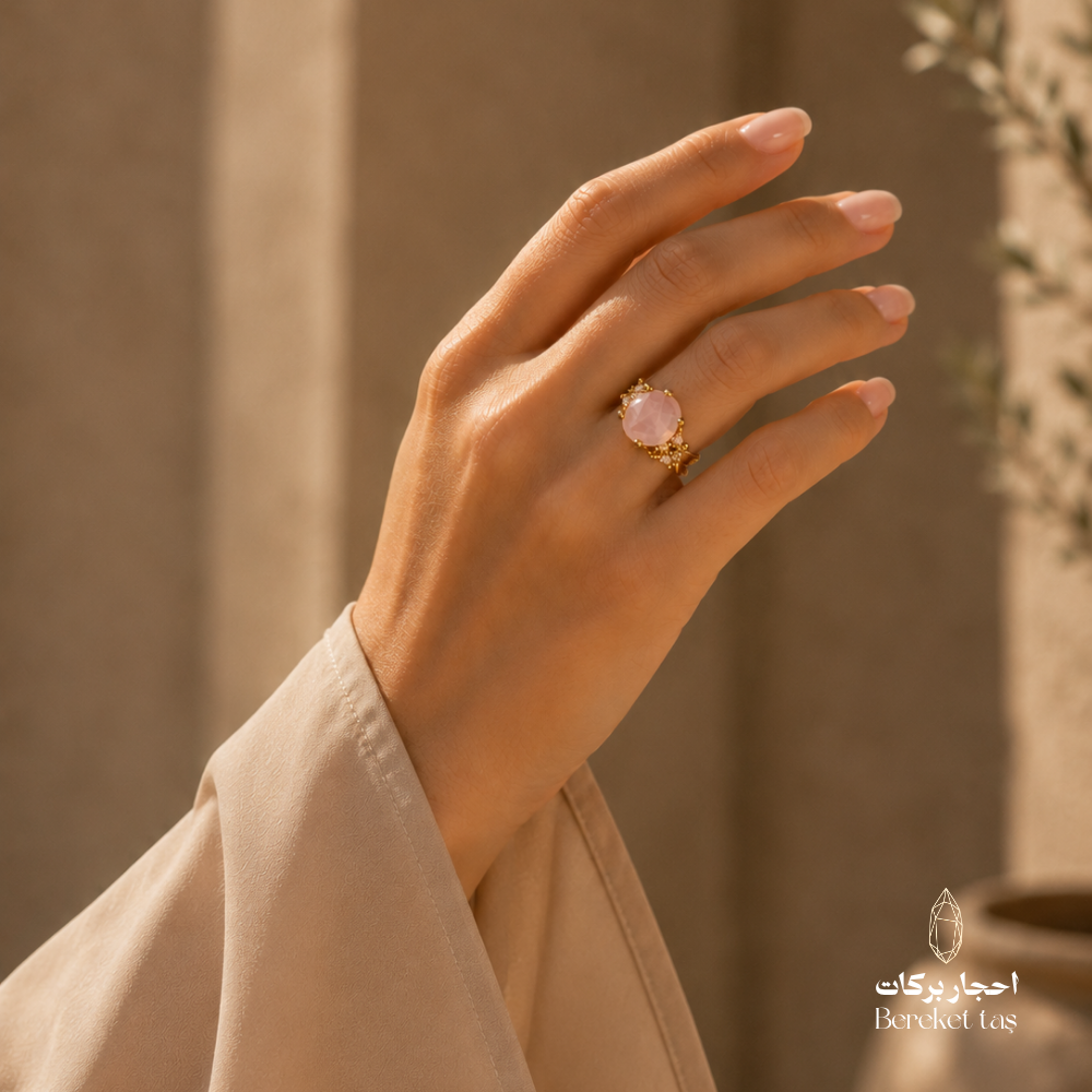 Natural rose quartz ring worn on hand with gold-plated copper setting