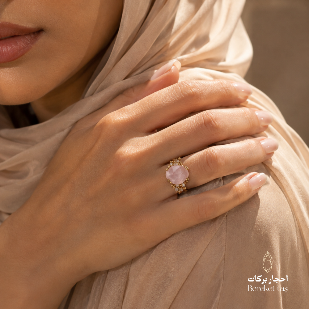 Natural rose quartz ring worn on hand with gold-plated copper setting