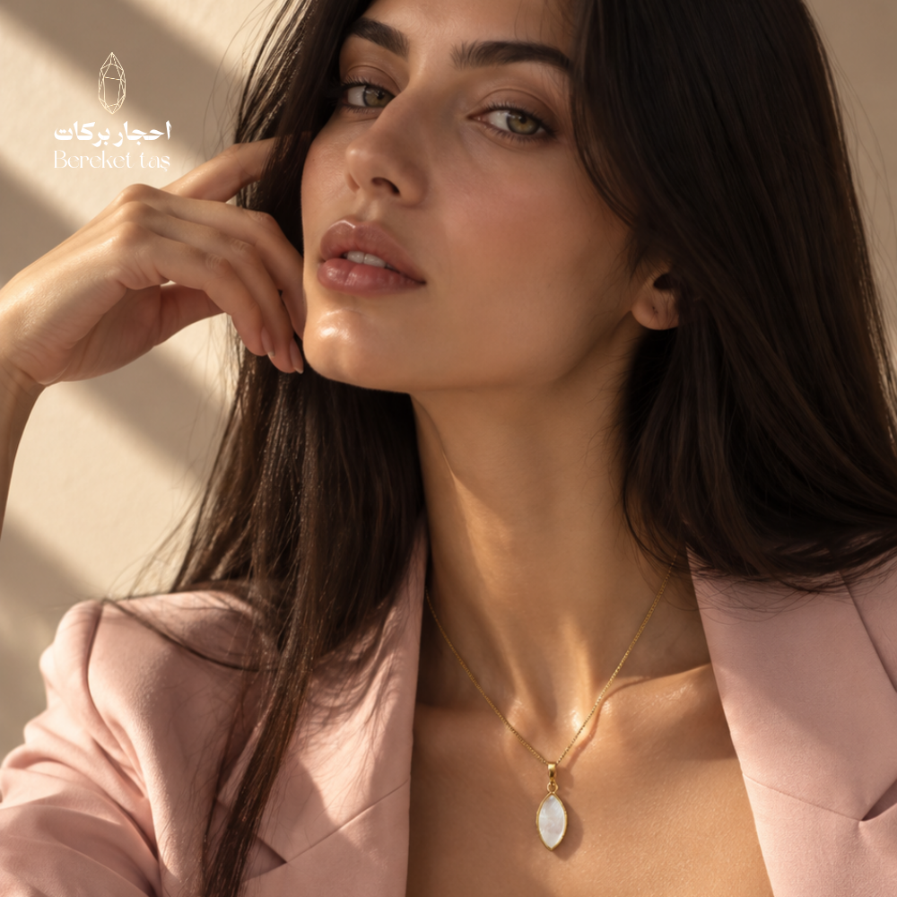 Natural shell stone pendant necklace with a gold-plated chain styled with an elegant pink outfit