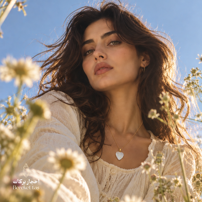 Natural Turkish Shell heart pendant necklace with a gold-plated chain styled with an elegant cream outfit