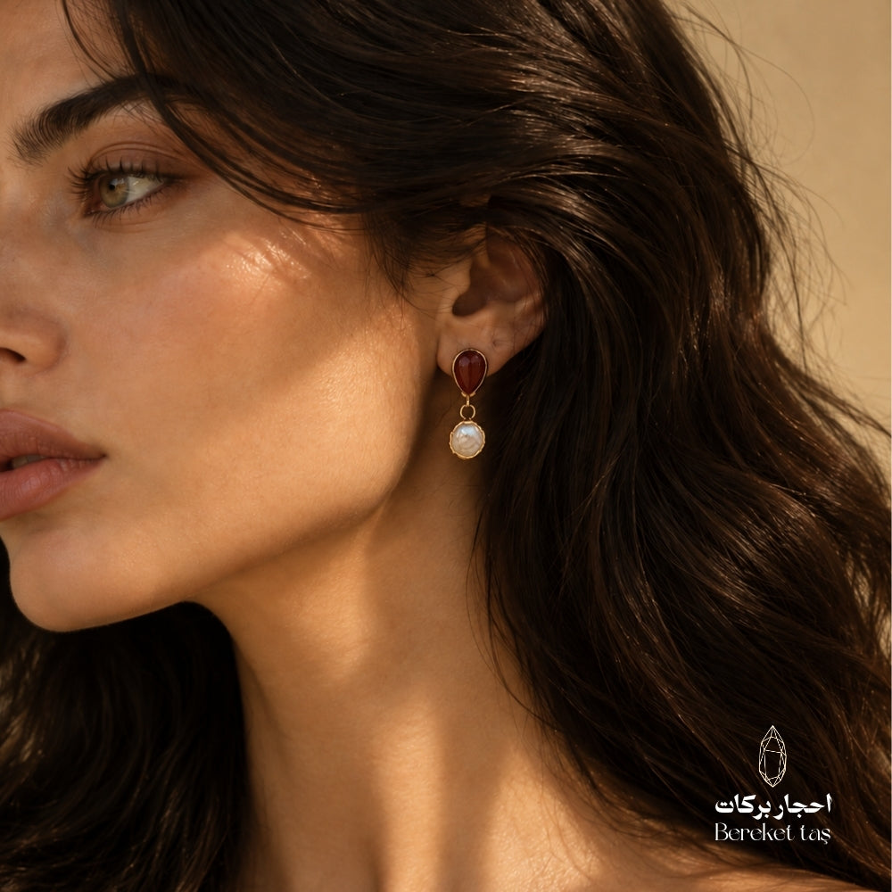 Side profile showcasing a Red Agate and natural Pearl drop earring with gold-plated metal