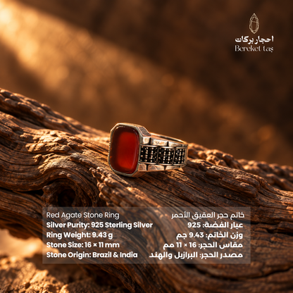 Natural Red Agate men's ring in 925 Sterling Silver shown from the side on textured wood, highlighting the oval gemstone and detailed silver setting.