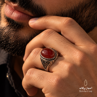 Close-up of a man wearing a natural Red Agate ring in 925 Sterling Silver, highlighting the polished red gemstone and ornate silver detailing.