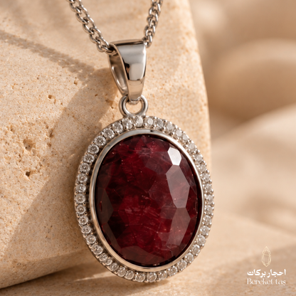 Close-up of a natural red Quartz pendant with a silver frame and sparkling details