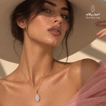 Natural Rose Quartz pendant necklace with gold-plated chain styled with an elegant evening look