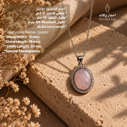 Rose quartz gemstone necklace with silver chain displayed on a natural stone background
