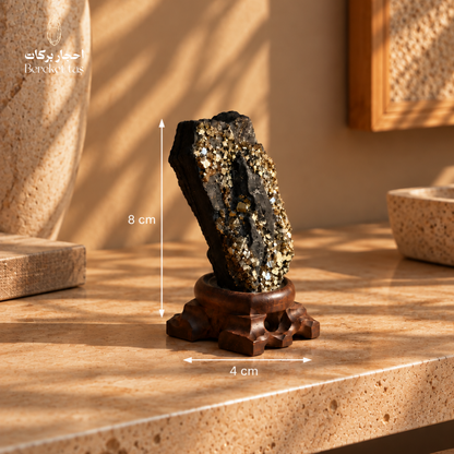 Natural black Shungite with golden Pyrite details showing the stone dimensions of 4 cm wide and 8 cm long