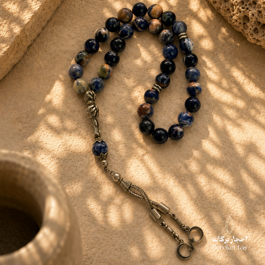 Natural Sodalite Stone Tasbih with deep blue beads and unique natural patterns on a warm beige surface