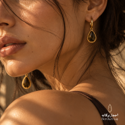 Elegant model wearing natural Tiger Eye drop earrings with gold-plated metal