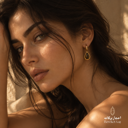 Natural Tiger Eye gemstone earring with gold-plated metal featured in an elegant close-up portrait