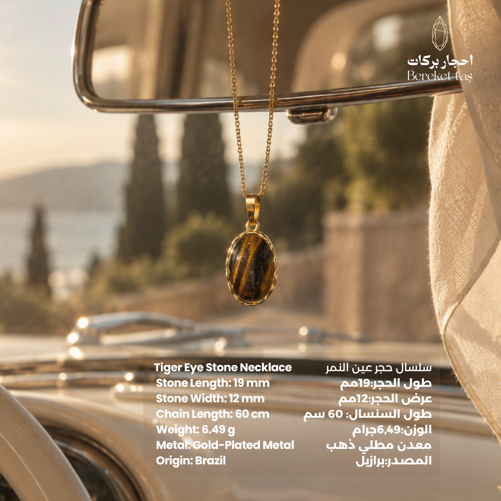 Natural Tiger Eye pendant necklace with a gold-plated chain displayed in an elegant outdoor setting