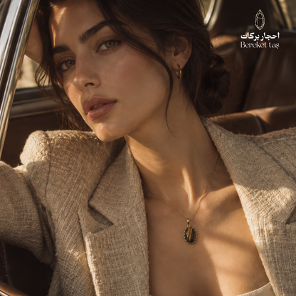 Natural Tiger Eye pendant necklace with a gold-plated chain styled with an elegant outfit