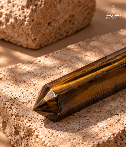 Natural South African Tiger’s Eye stone shown horizontally with a prominent golden chatoyant band and dark brown tones