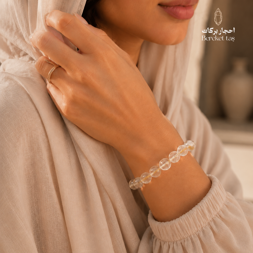 Transparent Topaz stone bracelet with 8 mm beads worn on the wrist