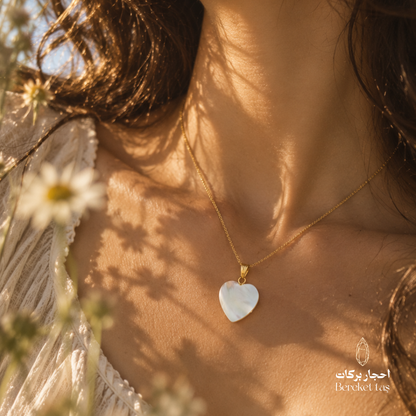 Natural Turkish Shell heart pendant necklace with a gold-plated chain worn in an elegant outdoor setting
