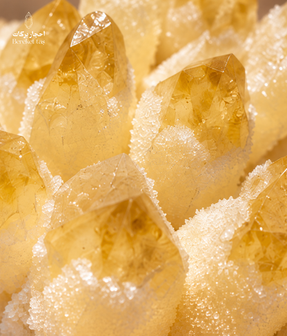 Close-up of natural yellow quartz crystal points with golden tones and white crystalline details