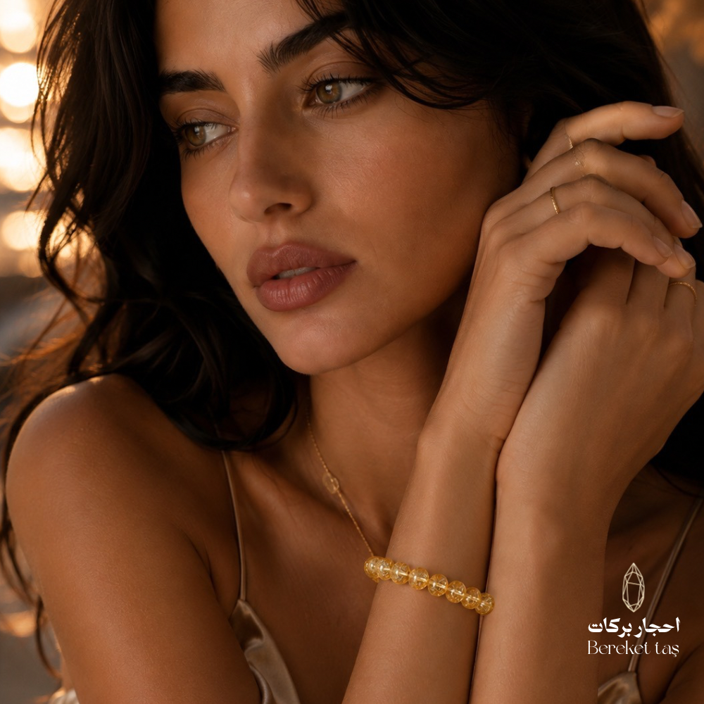 Natural yellow topaz stone bracelet worn on the wrist, featuring golden-yellow beads by Bereket Taş